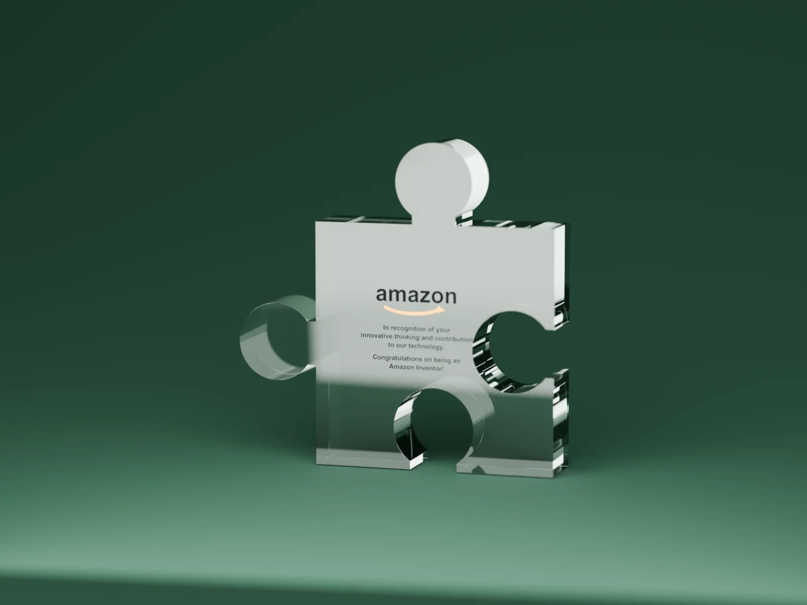 Clear acrylic puzzle-piece award printed with the Amazon logo and 'Congratulations on being an Amazon Inventor!'